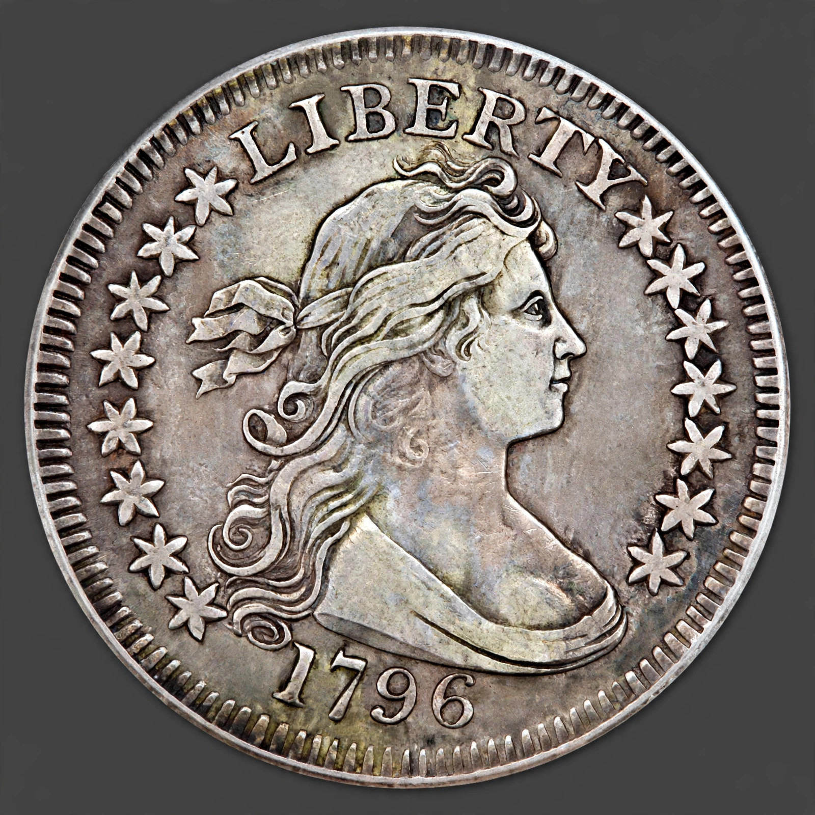 Illustration of a 1796 Draped Bust Quarter: Liberty with 15 stars; Small Eagle reverse with no denomination.